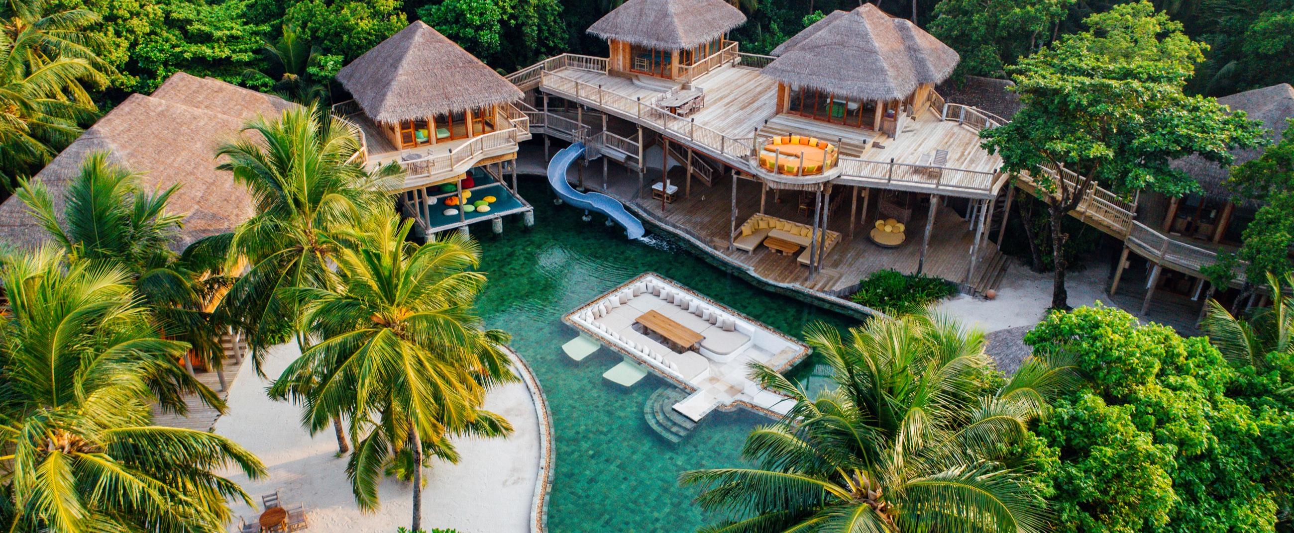 An aerial view of a private island villa with pool